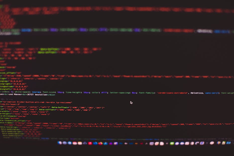 A close-up screenshot of a computer monitor displaying lines of HTML and CSS code within a text editor. The code includes tags such as <html>, <head>, <title>, and <link>, with syntax highlighting in 